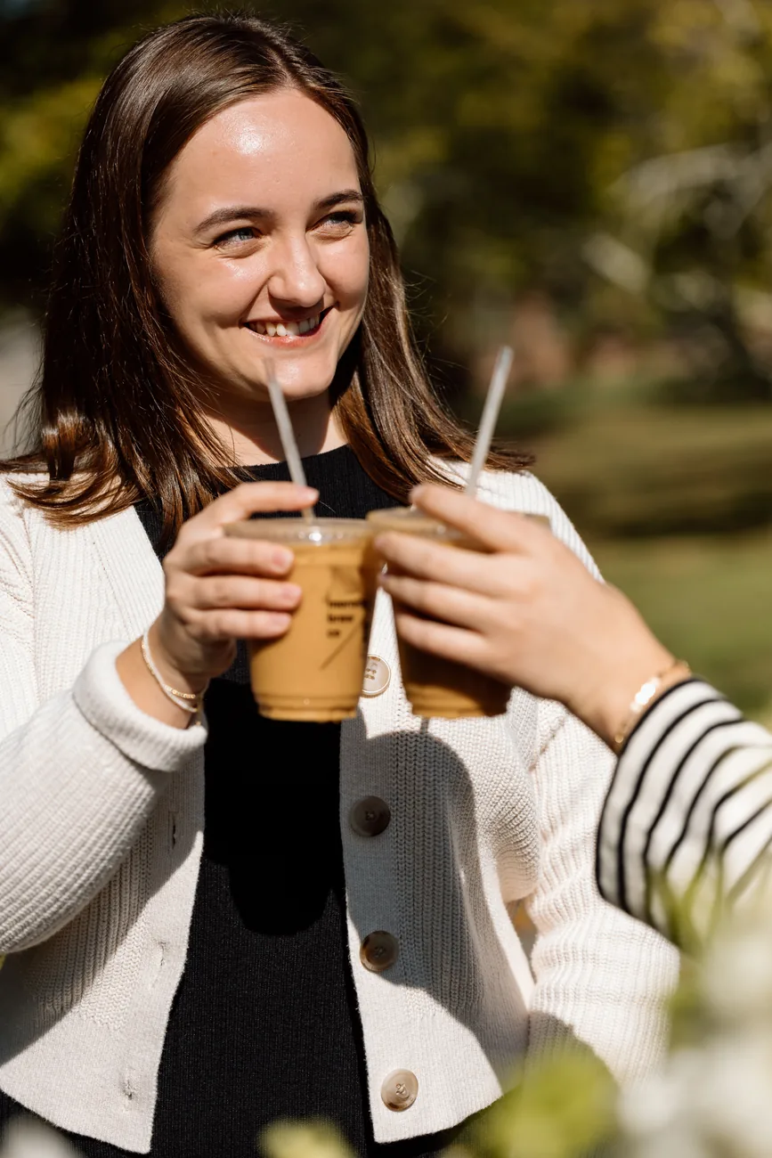Two guests toasting iced Morning Brew Co drinks outdoors