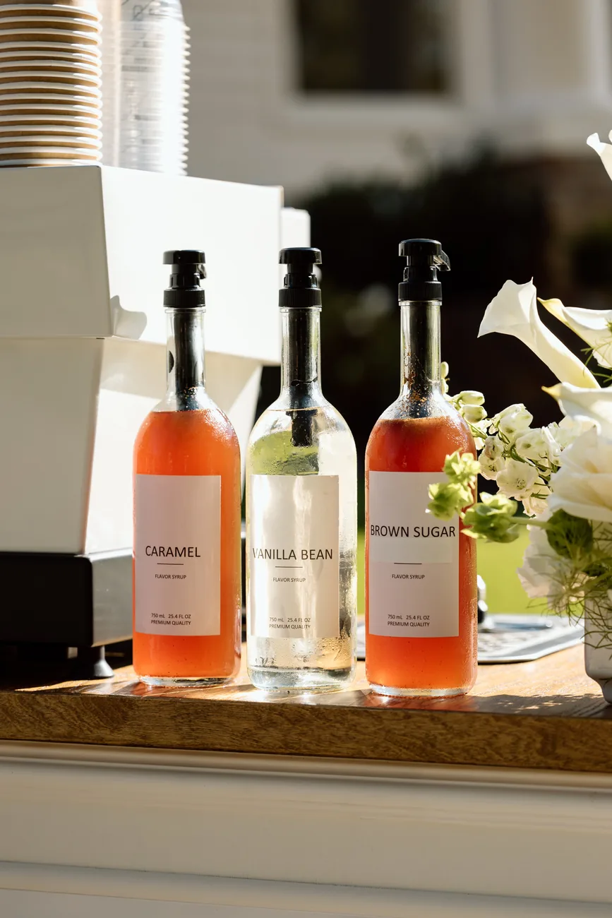 Syrup bottles and white flowers arranged on the Morning Brew Co cart
