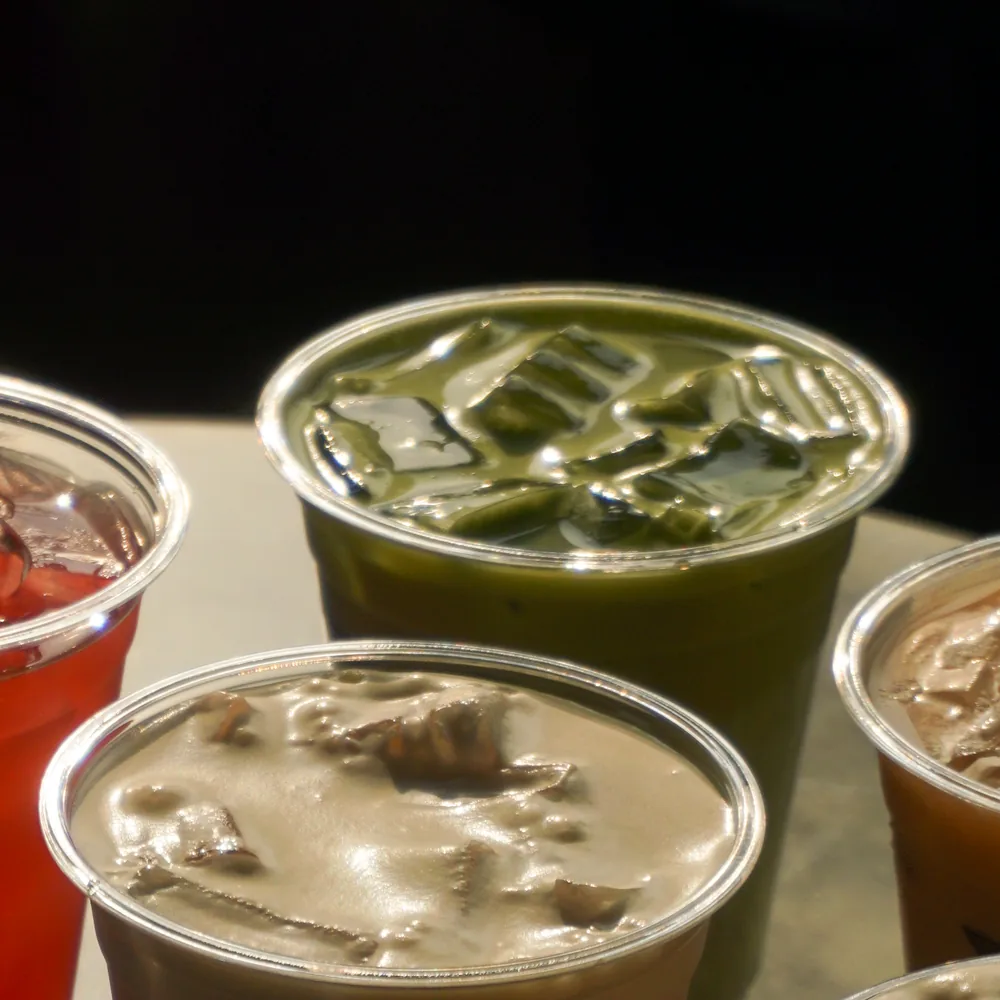 Iced drinks close up: a matcha, a refresher and two lattes