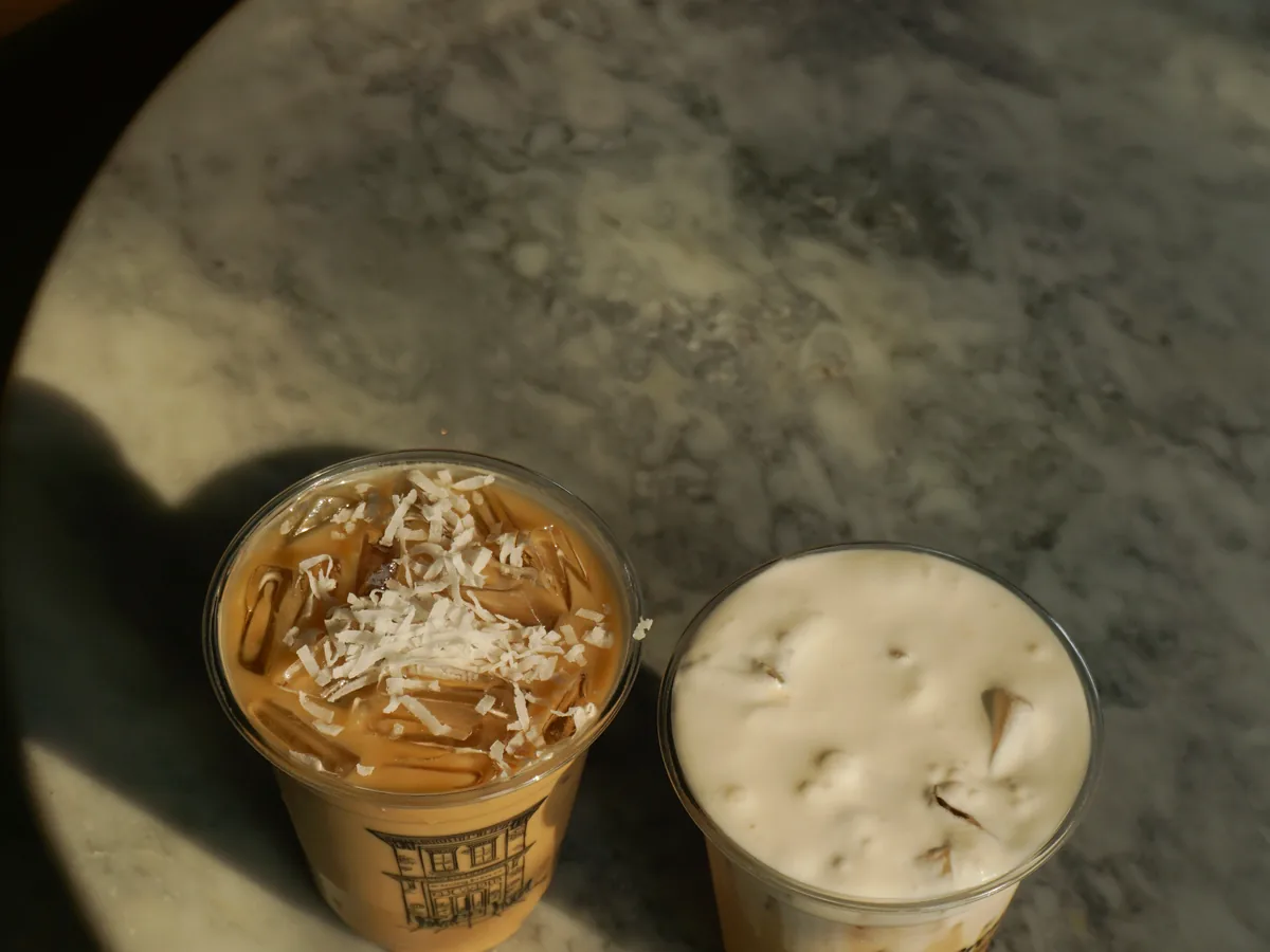 Two iced coffees on a marble table